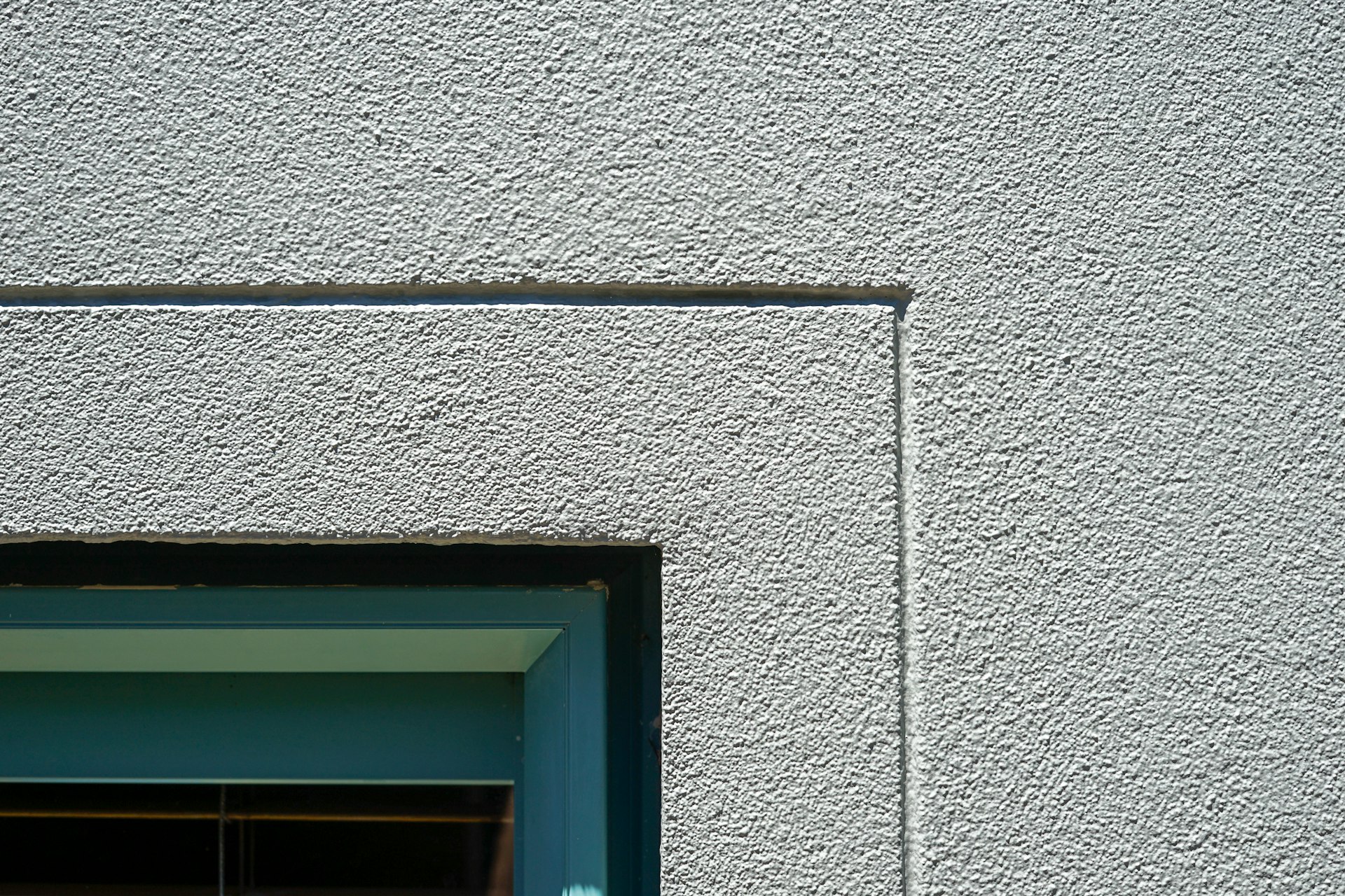 a cat sitting in a window sill of a building